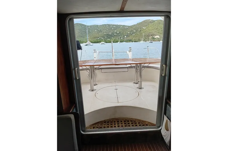  Yacht Photos Pics View from inside a 1995 Fountaine Pajot Marquises 56 yacht, overlooking a serene bay.