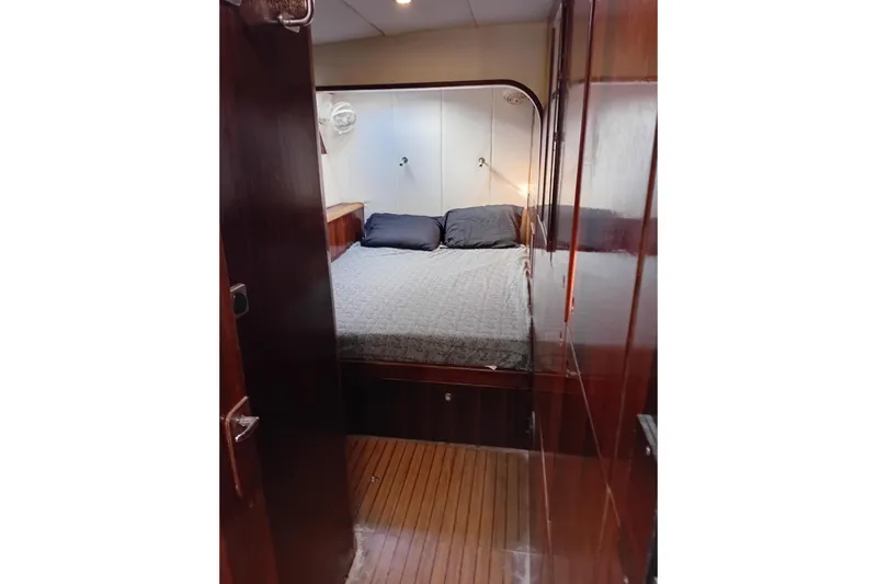  Yacht Photos Pics Cozy cabin interior of 1995 Fountaine Pajot Marquises 56 yacht with wooden finish.