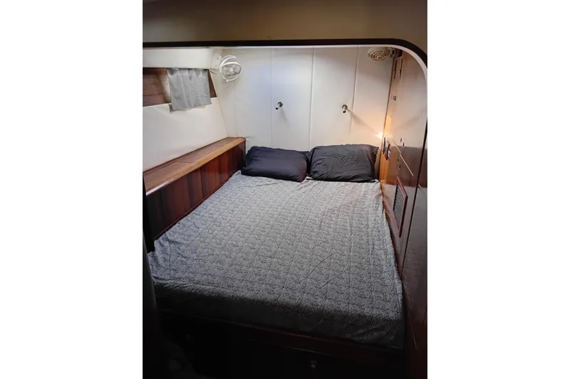  Yacht Photos Pics Cozy cabin interior of 1995 Fountaine Pajot Marquises 56 yacht with double bed.