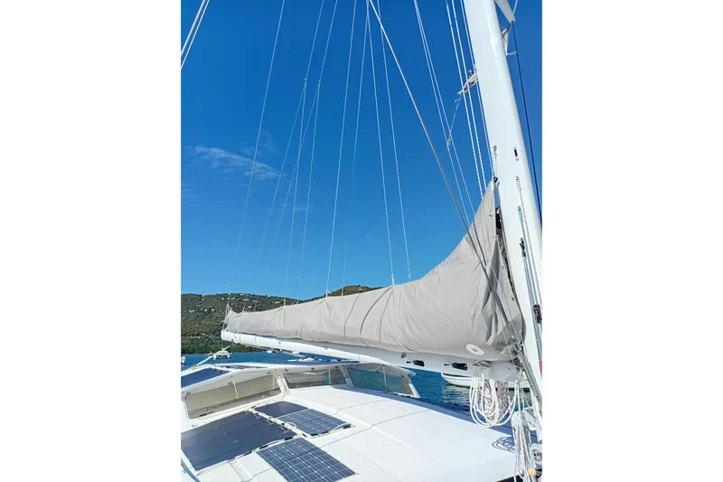  Yacht Photos Pics Sailboat deck view of 1995 Fountaine Pajot Marquises 56 under clear blue sky.