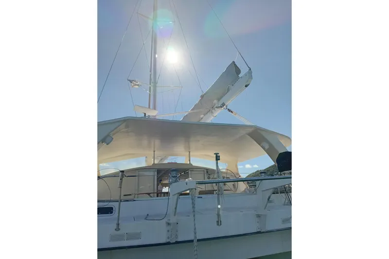  Yacht Photos Pics Fountaine Pajot Marquises 56 catamaran, 1995 model, with sails and mast under bright sun.