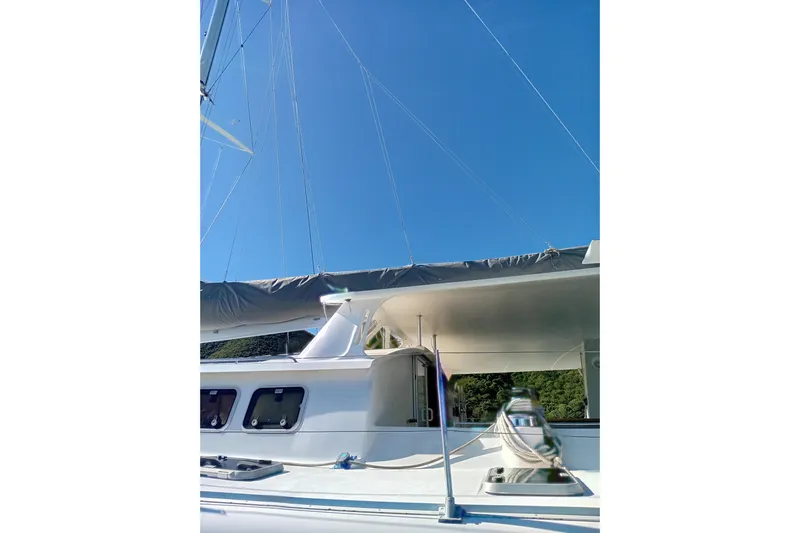  Yacht Photos Pics Sailing catamaran Fountaine Pajot Marquises 56, 1995 model, with clear blue sky background.