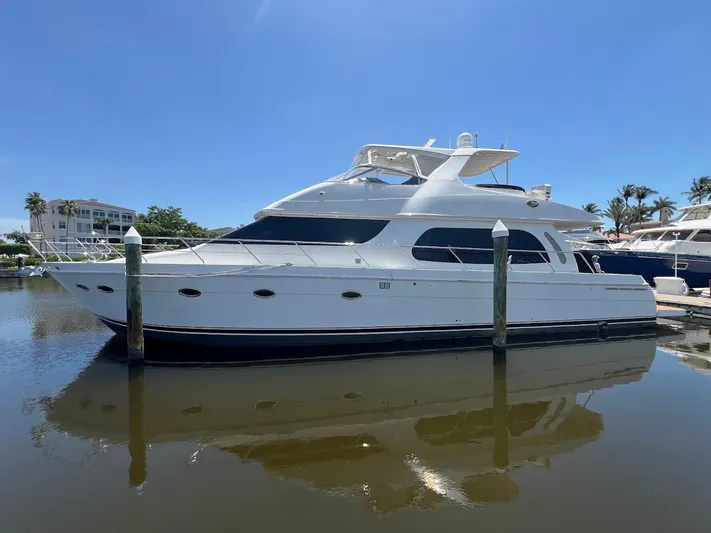 Roweboat Yacht Photos Pics 2006 Carver 56 Voyager yacht docked in a marina under clear blue skies.