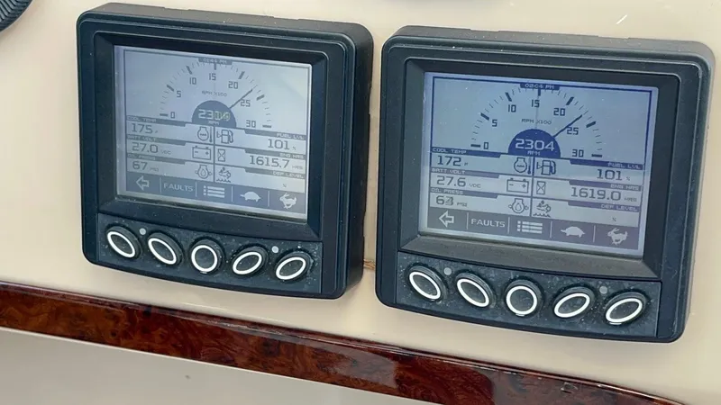 Roweboat Yacht Photos Pics Digital gauges on a 2006 Carver 56 Voyager yacht dashboard displaying engine metrics.