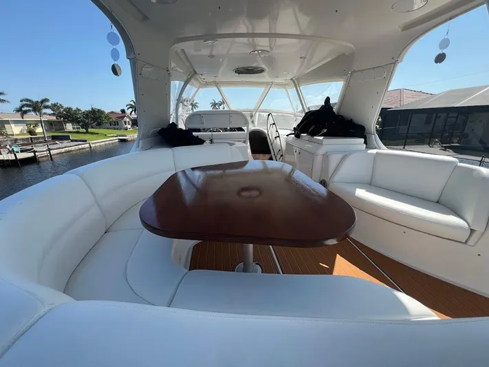 Roweboat Yacht Photos Pics Luxurious interior of 2006 Carver 56 Voyager yacht with white seating and wooden table.