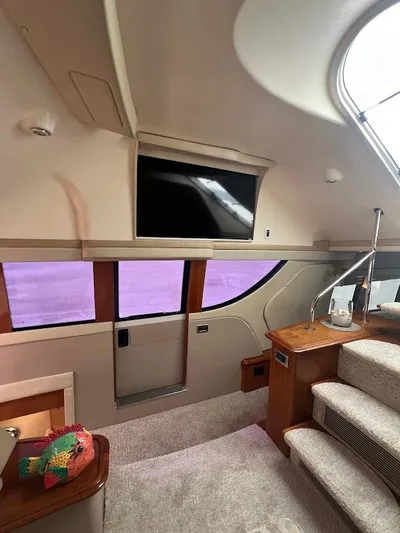 Roweboat Yacht Photos Pics Interior of 2006 Carver 56 Voyager yacht with TV, stairs, and decorative fish.