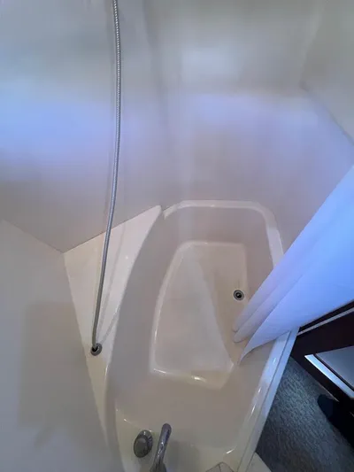 Roweboat Yacht Photos Pics Shower area in 2006 Carver 56 Voyager yacht, featuring a compact design and curtain.