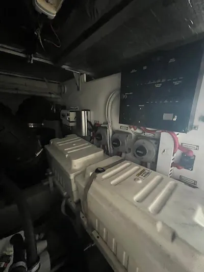 Roweboat Yacht Photos Pics Engine room of 2006 Carver 56 Voyager yacht, featuring mechanical components and control panel.