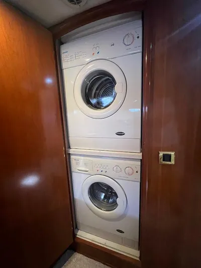 Roweboat Yacht Photos Pics Stacked washer and dryer in 2006 Carver 56 Voyager yacht interior.