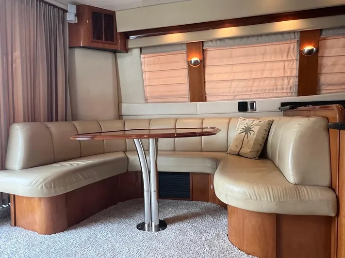 Roweboat Yacht Photos Pics Luxurious interior of 2006 Carver 56 Voyager yacht with plush seating and elegant table.