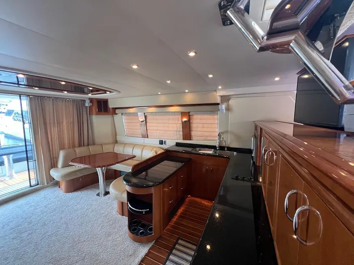 Roweboat Yacht Photos Pics Luxurious interior of 2006 Carver 56 Voyager yacht with elegant seating and modern kitchen.