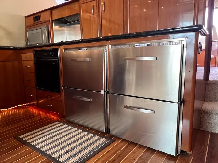 Roweboat Yacht Photos Pics Luxurious kitchen in 2006 Carver 56 Voyager yacht with stainless steel appliances.