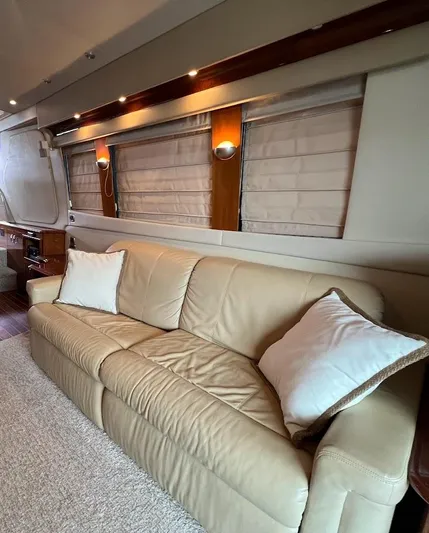 Roweboat Yacht Photos Pics Luxurious interior of 2006 Carver 56 Voyager yacht with beige leather sofa and elegant lighting.