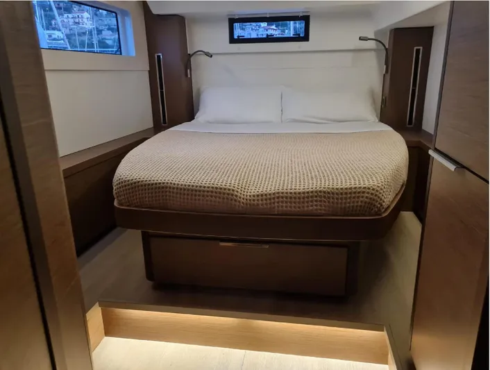 Martina Yacht Photos Pics Luxurious bedroom interior of 2021 Lagoon 46 yacht with modern design and cozy bedding.