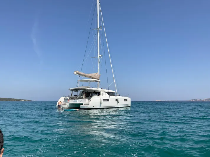 Martina Yacht Photos Pics Lagoon 46 catamaran sailing on clear blue waters under a sunny sky, 2021 model.