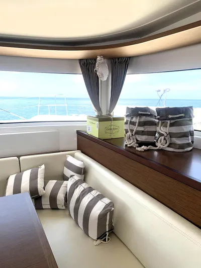 Martina Yacht Photos Pics Interior of 2021 Lagoon 46 yacht with striped cushions and ocean view.