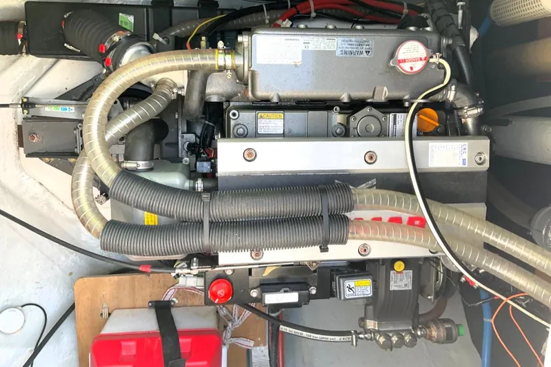 Martina Yacht Photos Pics Engine compartment of a 2021 Lagoon 46 catamaran, showcasing mechanical components and hoses.