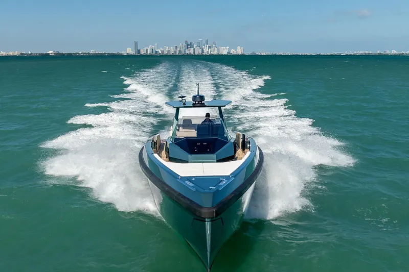 Wally Yacht Photos Pics 2021 Wally 48 Wally Tender cruising on open water with city skyline in background.