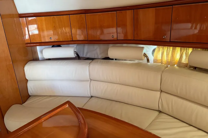  Yacht Photos Pics Luxurious interior of 2004 Sunseeker Superhawk 50 with cream leather seating and wooden cabinetry.