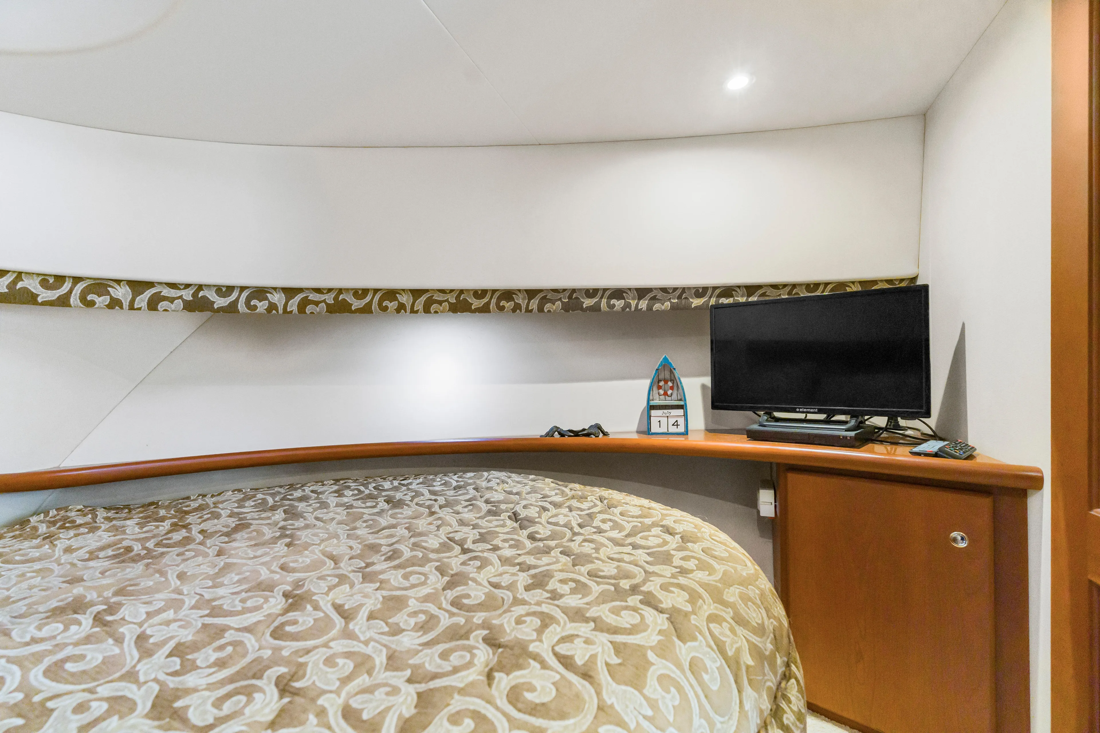 Water Cave Yacht Photos Pics Interior of 2005 Silverton 34 Convertible yacht with bed and TV setup.