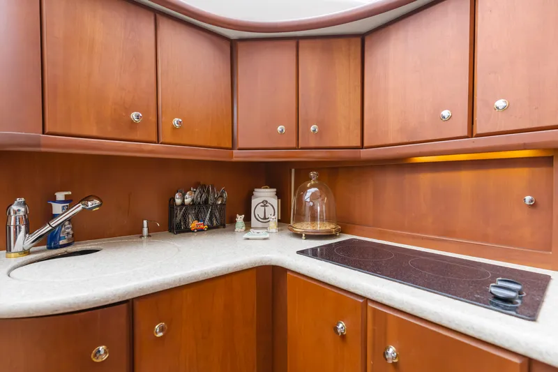 Water Cave Yacht Photos Pics 2005 Silverton 34 Convertible yacht kitchen with wooden cabinets and modern appliances.