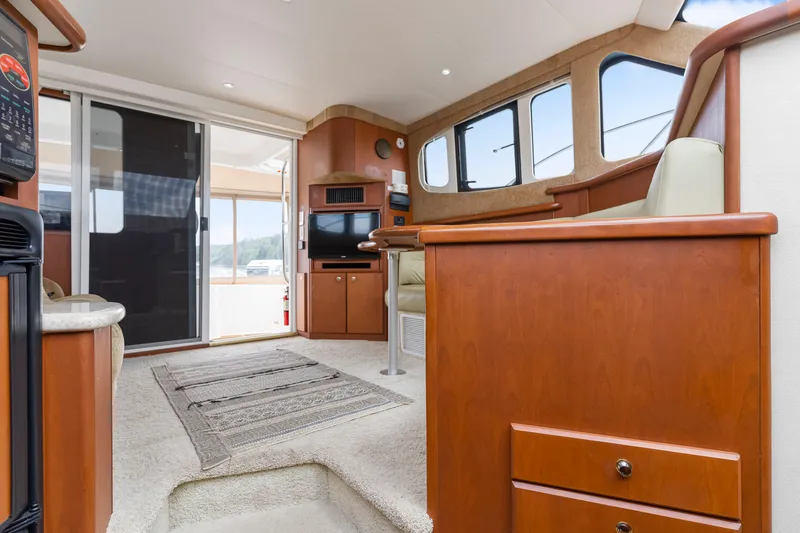 Water Cave Yacht Photos Pics Interior of 2005 Silverton 34 Convertible yacht with modern furnishings and large windows.