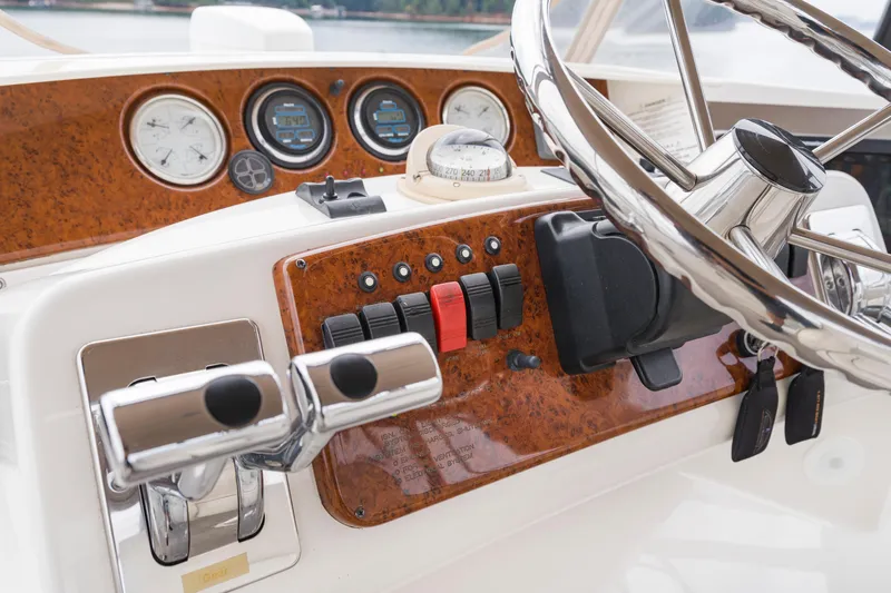 Water Cave Yacht Photos Pics Control panel of a 2005 Silverton 34 Convertible boat with steering wheel and gauges.
