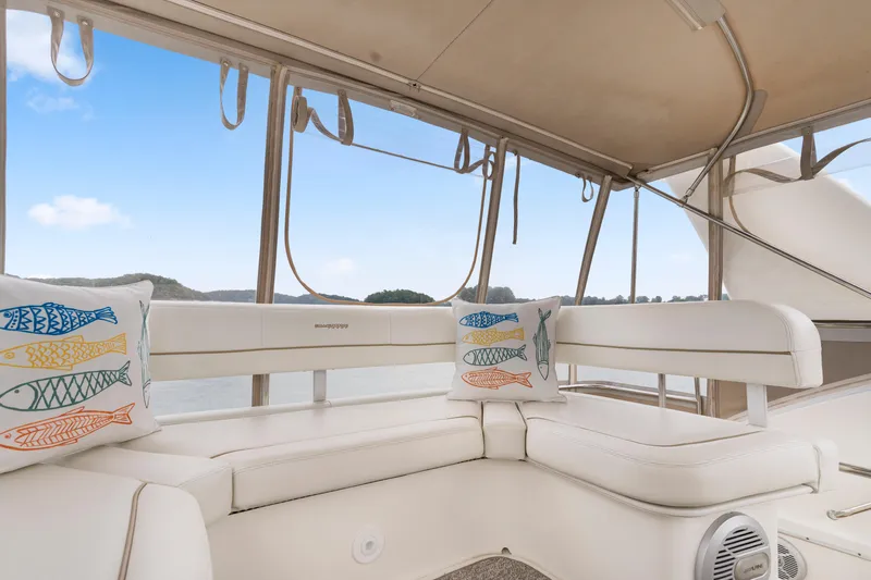 Water Cave Yacht Photos Pics Interior of 2005 Silverton 34 Convertible yacht with white seating and decorative fish pillows.