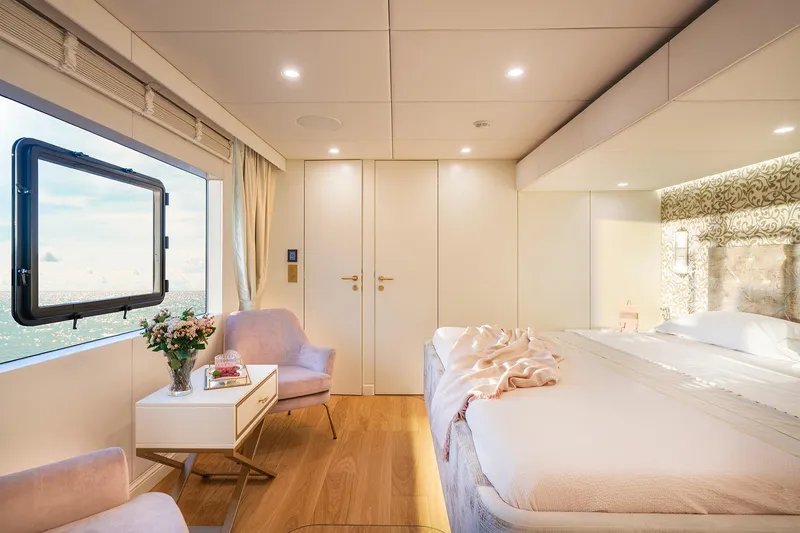  Yacht Photos Pics Luxurious bedroom interior on 2026 Sunreef 100 Power yacht, featuring elegant decor and ocean view.