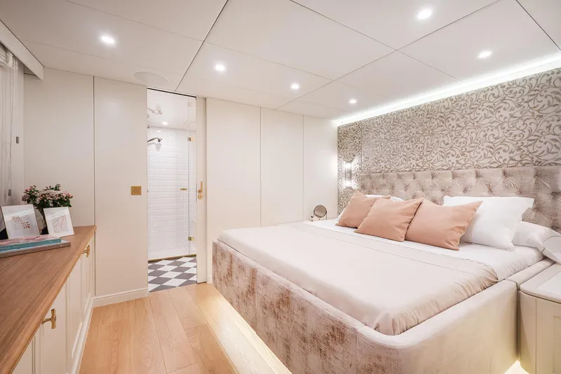  Yacht Photos Pics Luxurious bedroom interior on 2026 Sunreef 100 Power yacht, featuring elegant decor and ambient lighting.