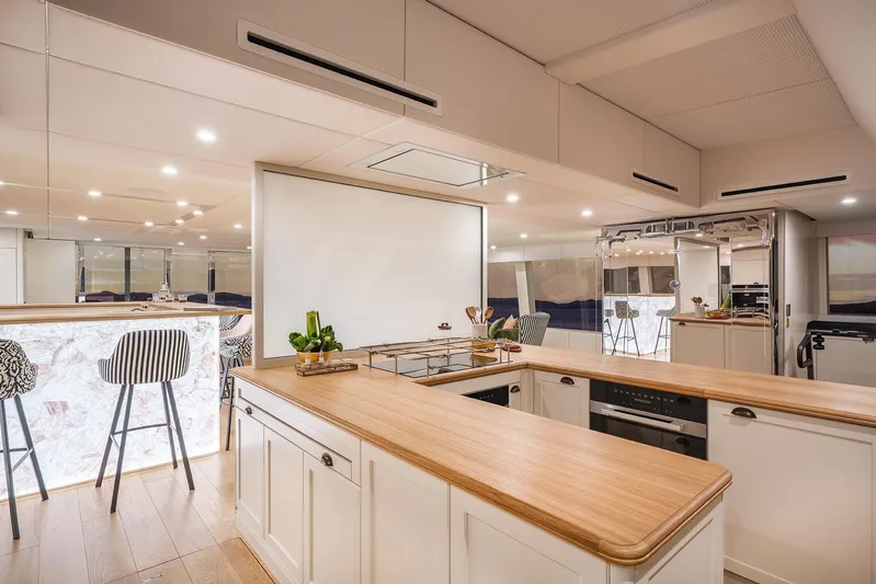  Yacht Photos Pics Luxurious kitchen interior of 2026 Sunreef 100 Sunreef Power yacht with modern design and wooden countertops.