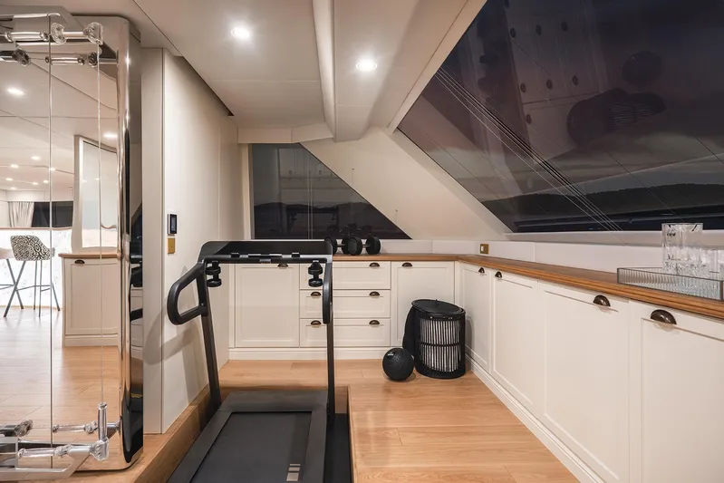 Yacht Photos Pics Fitness area on 2026 Sunreef 100 Power yacht with treadmill and modern decor.