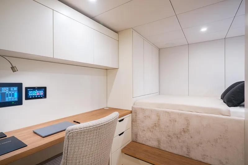  Yacht Photos Pics Luxurious cabin interior of 2026 Sunreef 100 Sunreef Power yacht with modern desk and bed.