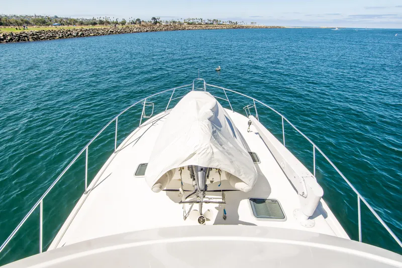 Play’n Hooky Yacht Photos Pics Bow view of 1999 Riviera 43 Open Flybridge yacht on open water.