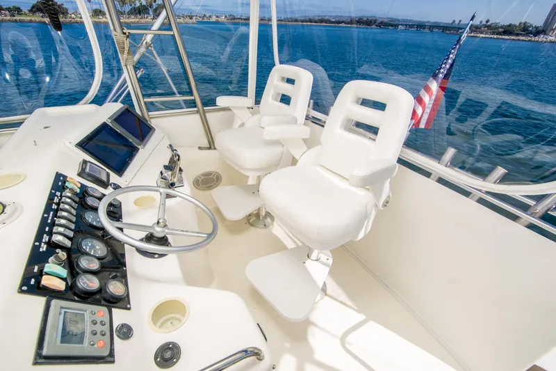 Play’n Hooky Yacht Photos Pics 1999 Riviera 43 Open Flybridge helm with dual white captain chairs and ocean view.