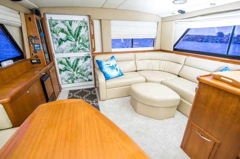 Play’n Hooky Yacht Photos Pics Luxurious interior of 1999 Riviera 43 Open Flybridge yacht with cream leather seating.