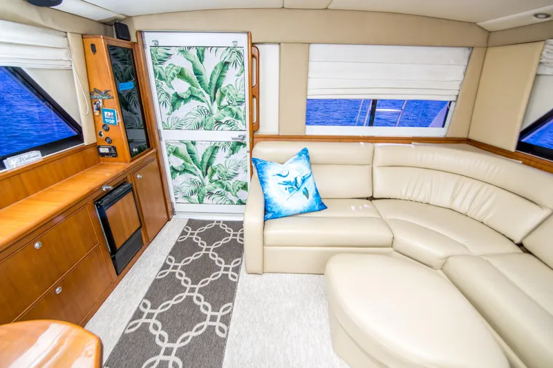Play’n Hooky Yacht Photos Pics Luxurious interior of 1999 Riviera 43 Open Flybridge yacht with leather seating and tropical decor.