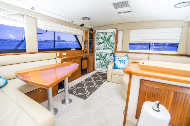 Play’n Hooky Yacht Photos Pics Luxurious interior of 1999 Riviera 43 Open Flybridge yacht with elegant seating and decor.