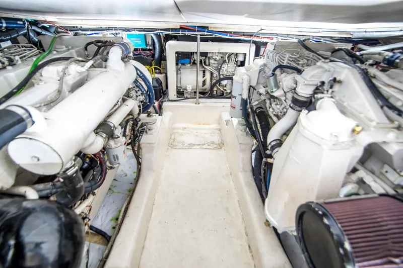 Play’n Hooky Yacht Photos Pics Engine room of 1999 Riviera 43 Open Flybridge with visible machinery and components.