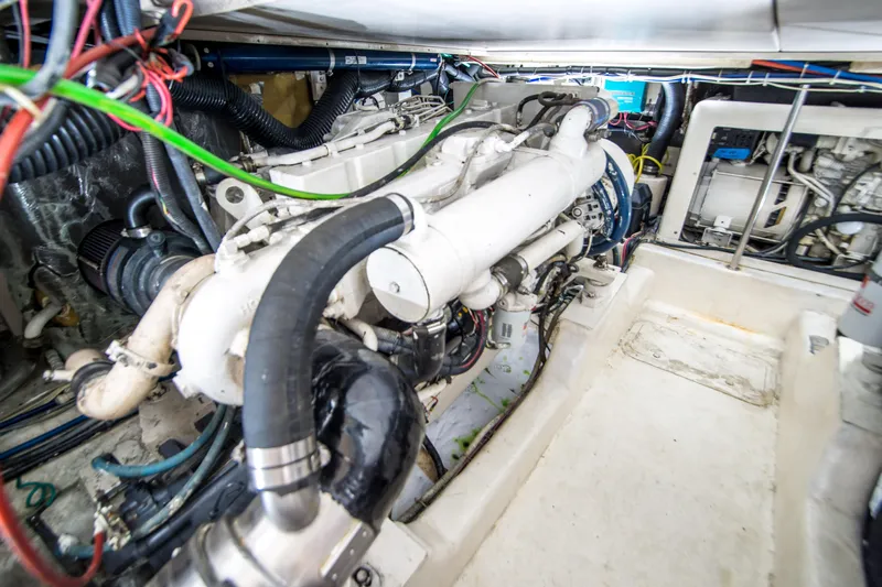 Play’n Hooky Yacht Photos Pics Engine room of 1999 Riviera 43 Open Flybridge with visible machinery and wiring.