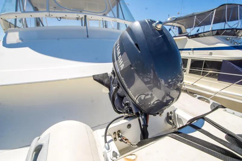 Play’n Hooky Yacht Photos Pics 1999 Riviera 43 Open Flybridge with Yamaha outboard motor, docked under clear blue sky.