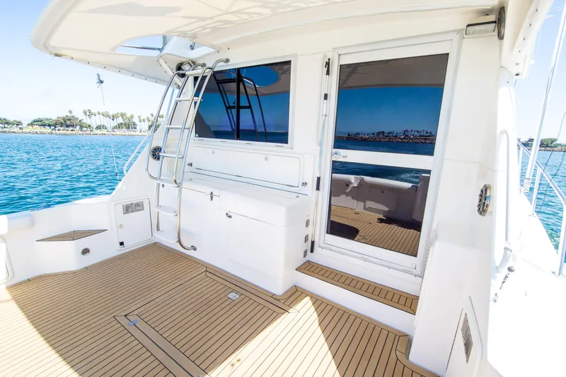 Play’n Hooky Yacht Photos Pics 1999 Riviera 43 Open Flybridge yacht deck with ocean view and sleek design.