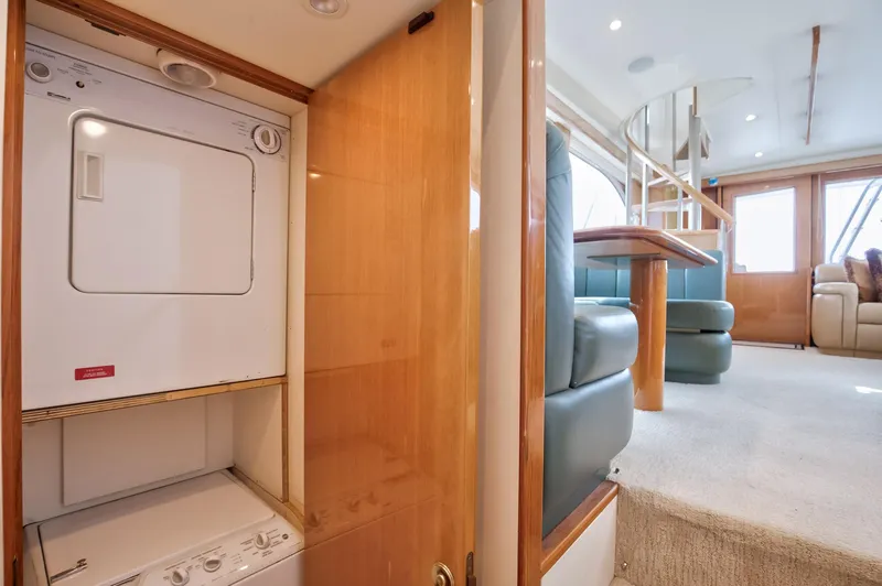 Good To Go Yacht Photos Pics Interior of 2002 Viking 61 yacht with laundry area and seating.