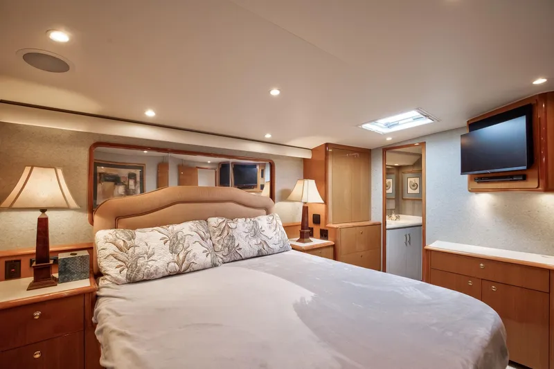 Good To Go Yacht Photos Pics Luxurious bedroom interior of a 2002 Viking 61 yacht with elegant lighting and decor.