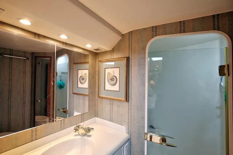 Good To Go Yacht Photos Pics Luxurious bathroom in 2002 Viking 61 yacht with elegant decor and modern fixtures.