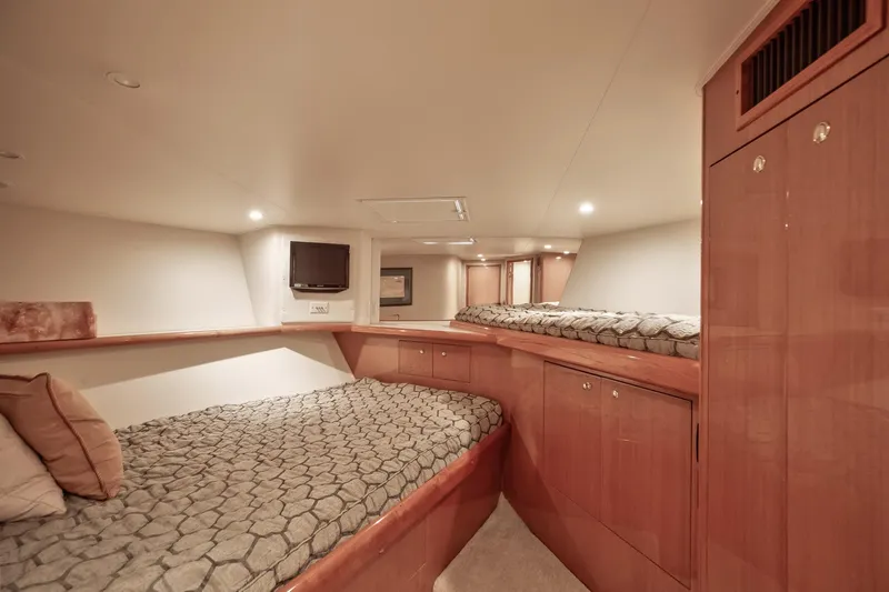 Good To Go Yacht Photos Pics Luxurious cabin interior of 2002 Viking 61 yacht with cozy bedding and wooden cabinetry.