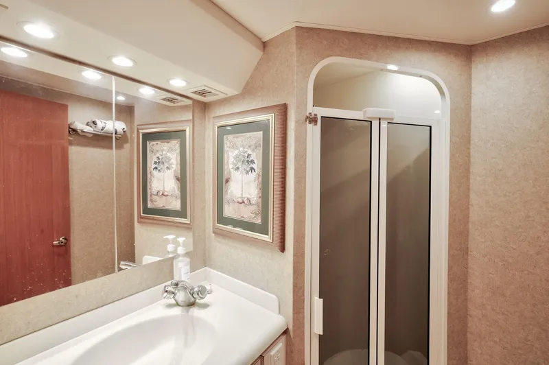 Good To Go Yacht Photos Pics Luxurious bathroom in 2002 Viking 61 yacht with shower and elegant decor.