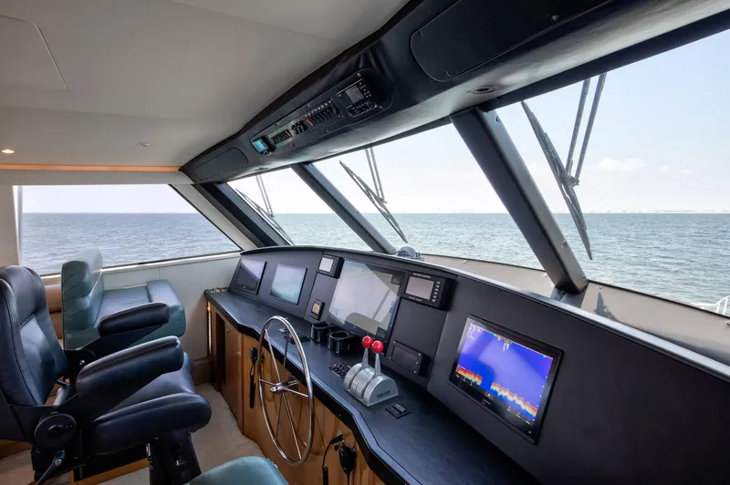 Good To Go Yacht Photos Pics Interior view of 2002 Viking 61 yacht cockpit with ocean view and navigation equipment.