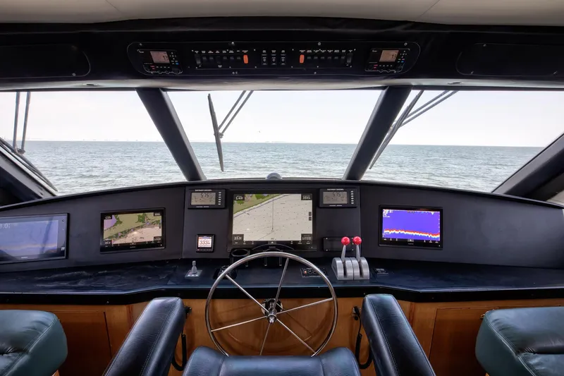 Good To Go Yacht Photos Pics Cockpit view of 2002 Viking 61 yacht with navigation screens and steering wheel.