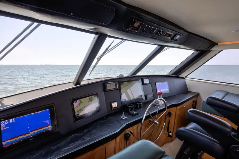 Good To Go Yacht Photos Pics Helm of 2002 Viking 61 yacht with navigation screens and ocean view.